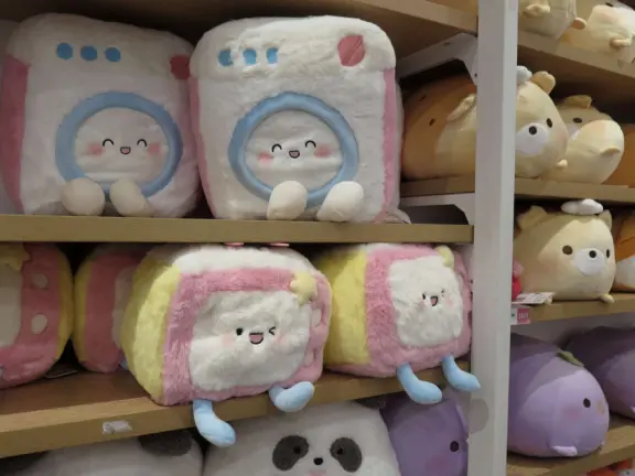 A modern, elegant mall with a Miniso Asian goods store, Hollister Co. teen clothing, Claire's Accessories, Hobby Lobby crafts, The Children's Place kids clothing, and large department stores.