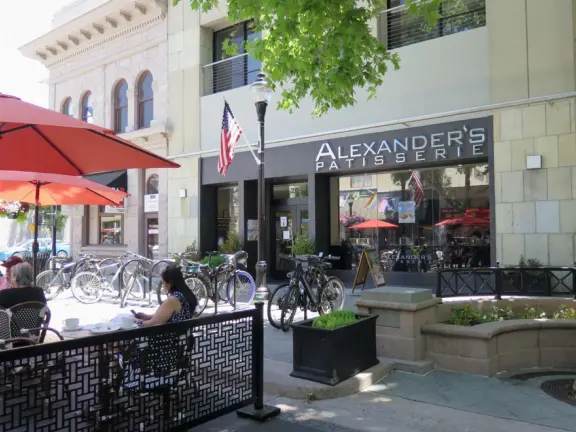 Pedestrian-only area with cafes, flowers baskets, and street musicians.