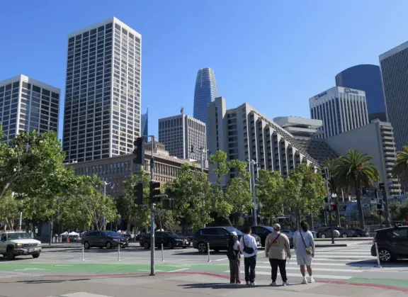 Wide, 3-mile-long walkway on the waterfront with blue lampposts, canary palms, lawns, modern sculptures, and views of the Bay Bridge. Find ferries, restaurants, touristy shops, and museums.