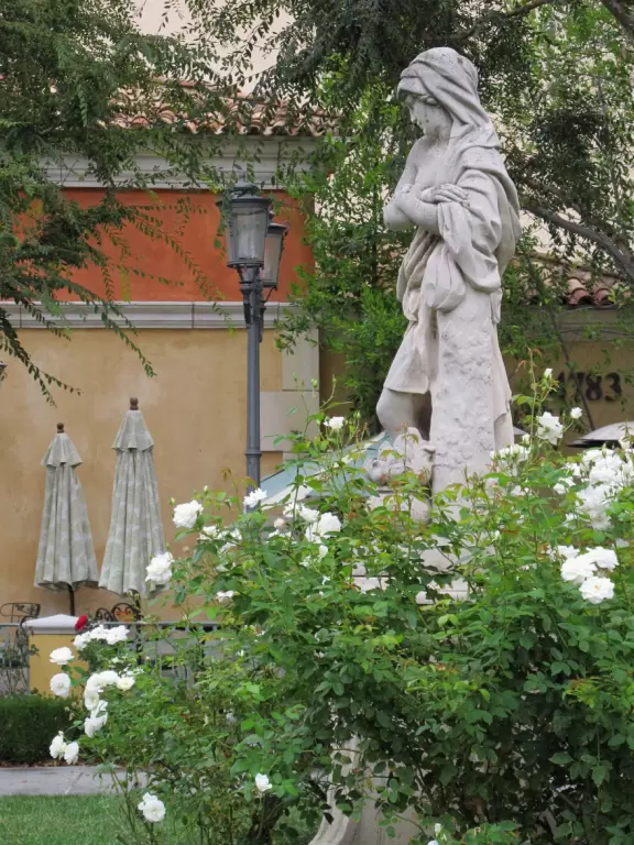 A shopping plaza with sidewalks cafes and shops that would look like Europe if it weren't so new!