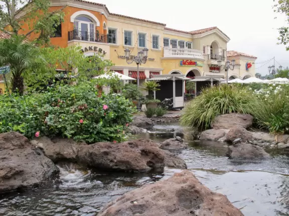 A shopping plaza with sidewalks cafes and shops that would look like Europe if it weren't so new!