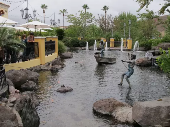 A shopping plaza with sidewalks cafes and shops that would look like Europe if it weren't so new!