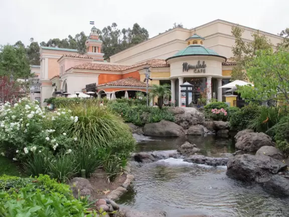 A shopping plaza with sidewalks cafes and shops that would look like Europe if it weren't so new!