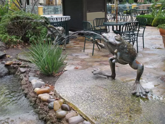 A shopping plaza with sidewalks cafes and shops that would look like Europe if it weren't so new!