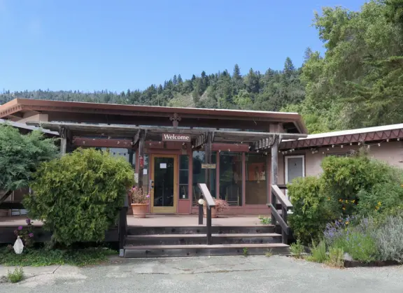 Stunning view from a bench on vertical cliffs above blue-green water.
