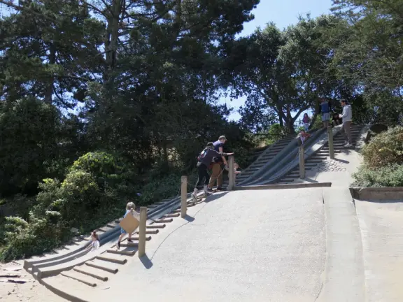Antique carousel in round building, cute kiosk with fancy drinks, historic sandstone building, and children's playground with wave sculpture and huge slide down the hill!