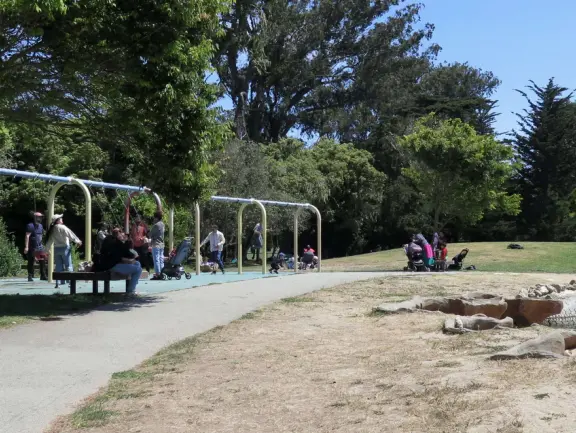 Antique carousel in round building, cute kiosk with fancy drinks, historic sandstone building, and children's playground with wave sculpture and huge slide down the hill!