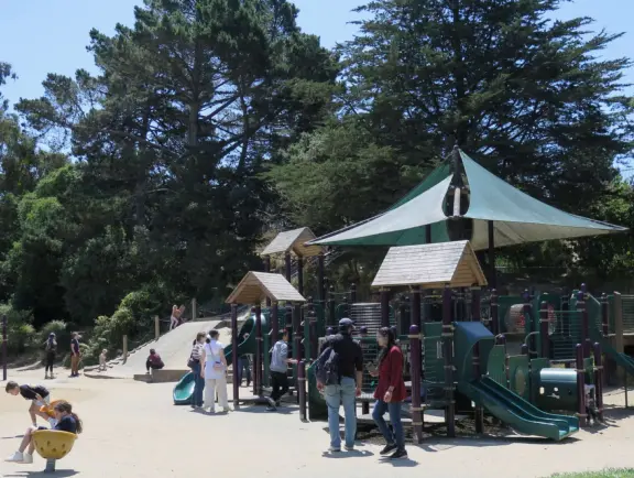 Antique carousel in round building, cute kiosk with fancy drinks, historic sandstone building, and children's playground with wave sculpture and huge slide down the hill!