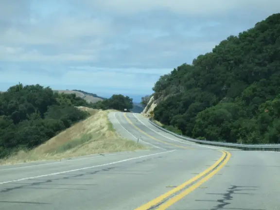 A beautiful drive above layers of hills, with views of the ocean. You pass wineries and farms to visit.