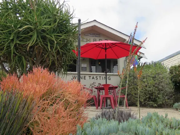 Nice little main street, with cafes, pretty storefronts, park, swinging bridge over a creek with tropical vegetation, and neighborhood with white picket fences and gardens.