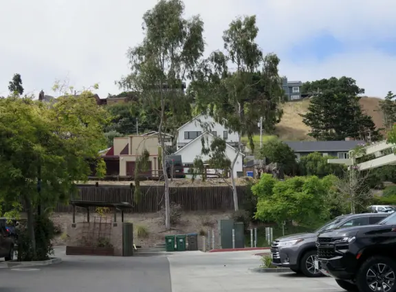 Nice little main street, with cafes, pretty storefronts, park, swinging bridge over a creek with tropical vegetation, and neighborhood with white picket fences and gardens.