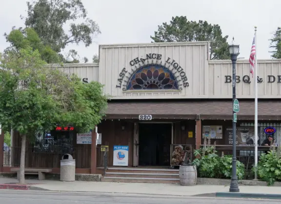 Nice little main street, with cafes, pretty storefronts, park, swinging bridge over a creek with tropical vegetation, and neighborhood with white picket fences and gardens.