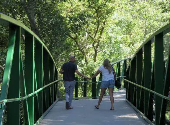 Wide partially shady path that leads through oak forest, past a market, and a Secret Garden with live music, to Avila Beach.