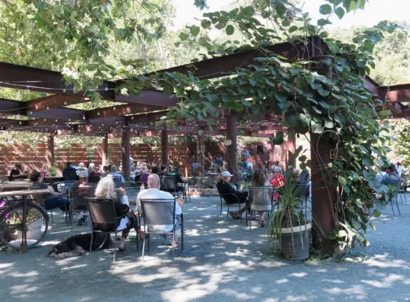 Wide partially shady path that leads through oak forest, past a market, and a Secret Garden with live music, to Avila Beach.