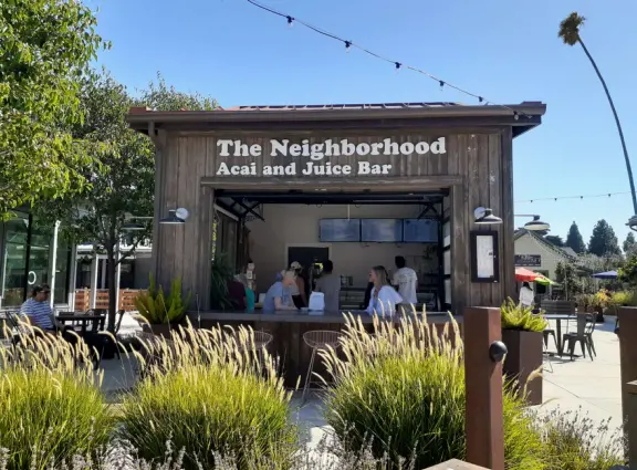 Attractive public market with sunny outdoor space and cute balcony upstairs.