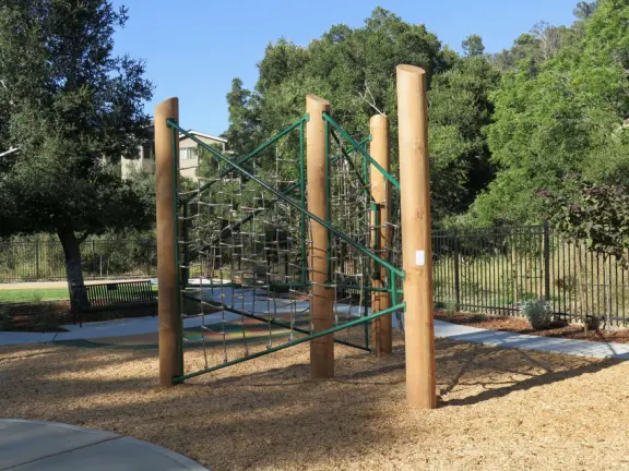 Narrow tree-lined streets in the Anholm District with historic houses and views of Madonna Mountain and Bishop Peak, and a sweet deli.