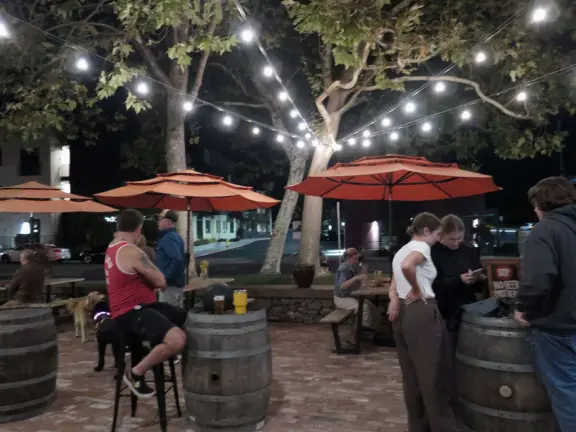 Trendy area with coffee shop, beer garden, wine bars, and cider bar, in industrial-style architecture with murals.