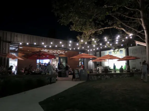 Trendy area with coffee shop, beer garden, wine bars, and cider bar, in industrial-style architecture with murals.