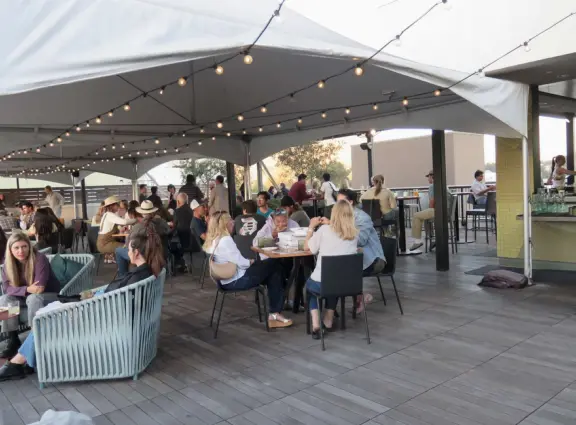 A main street of late 19th century storefronts, popular cafes, and a hip college scene. Recently, suffering an epidemic of homelessness relating to mental health problems.