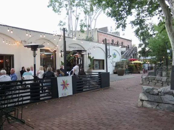 A main street of late 19th century storefronts, popular cafes, and a hip college scene. Recently, suffering an epidemic of homelessness relating to mental health problems.