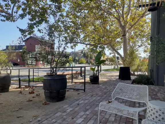 Trendy area with coffee shop, beer garden, wine bars, and cider bar, in industrial-style architecture with murals.