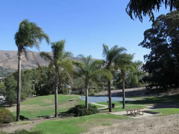 Hilltop park with basketball court with views, picnic tables, eucalyptus trees, and a difficult two-mile out-and-back trail.