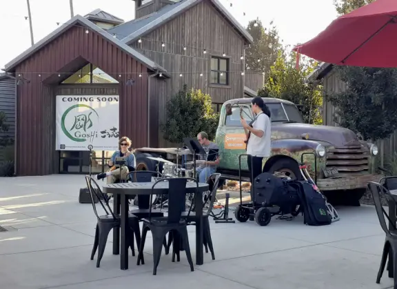 Attractive public market with sunny outdoor space and cute balcony upstairs.