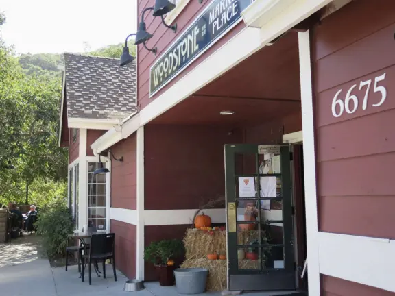 Wide partially shady path that leads through oak forest, past a market, and a Secret Garden with live music, to Avila Beach.