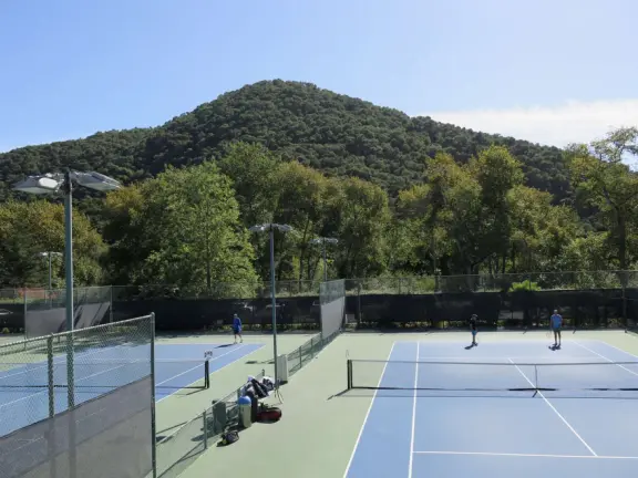 Wide partially shady path that leads through oak forest, past a market, and a Secret Garden with live music, to Avila Beach.