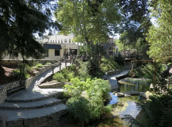 A main street of late 19th century storefronts, popular cafes, and a hip college scene. Recently, suffering an epidemic of homelessness relating to mental health problems.