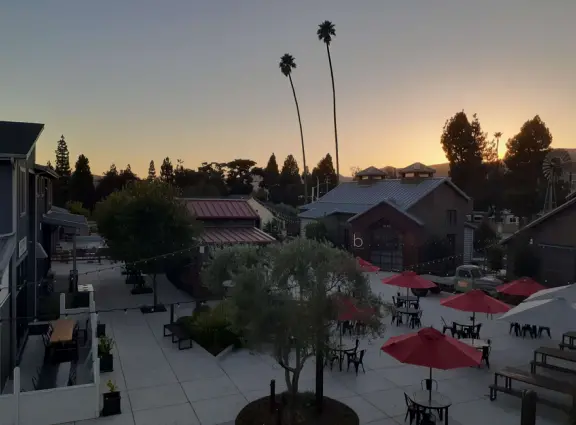Attractive public market with sunny outdoor space and cute balcony upstairs.