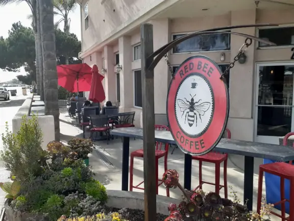 Cute area on Grand Avenue with colorful sidewalk, palm trees, ocean air, and a few good cafes.