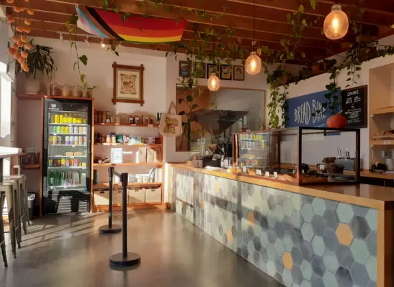 A main street of late 19th century storefronts, popular cafes, and a hip college scene. Recently, suffering an epidemic of homelessness relating to mental health problems.