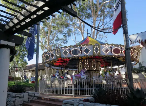 Spanish mission from late 18th century, in downtown San Luis Obispo, with giant roses in the garden behind and a lively plaza in front.