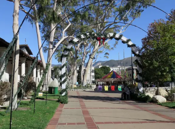 Spanish mission from late 18th century, in downtown San Luis Obispo, with giant roses in the garden behind and a lively plaza in front.