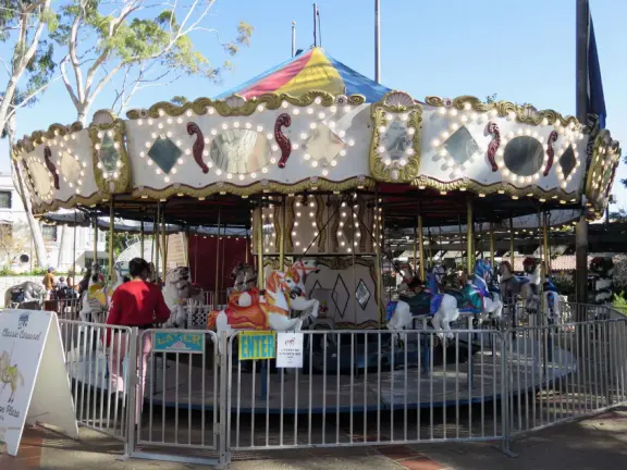 Spanish mission from late 18th century, in downtown San Luis Obispo, with giant roses in the garden behind and a lively plaza in front.