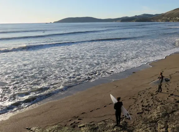 Stretch of grass with a paved walkway, flower beds, wonderful ocean views to Avila Beach, and monterey cypress trees.