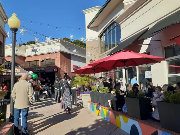 A main street of late 19th century storefronts, popular cafes, and a hip college scene. Recently, suffering an epidemic of homelessness relating to mental health problems.