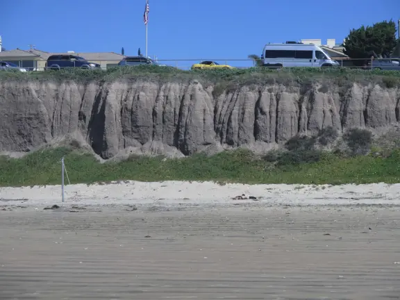 Stairs surrounded by purple and yellow ice plant, leading down to Pismo Beach. Volleyball, long walks, caves, pier and boardwalk.