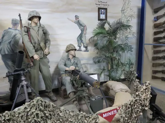 Military museum with jet fighters, World War I and II exhibits, historic and racing cars in Woodland Auto Display, bombs and missiles, communications equipment, and jeeps.