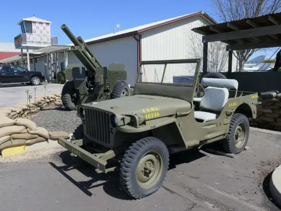 Military museum with jet fighters, World War I and II exhibits, historic and racing cars in Woodland Auto Display, bombs and missiles, communications equipment, and jeeps.