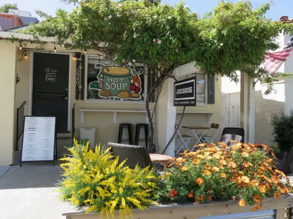 Sunny town with a cute main street, and City Hall with beautiful Sunken Garden with sculptures, tall old trees including magnolia trees, and fountains.