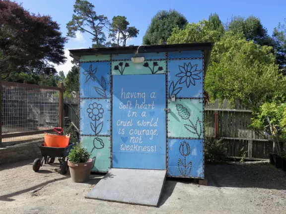 Garden in a sunny, sheltered spot, with cottage with turret under redwood trees, Buddhist gazebo, goats, and flowers galore! Seasonal pumpkins and Christmas market!