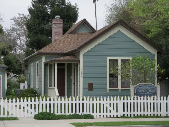 Large lush park with tall tropical trees, attractive bandstand, cute toddler playground, historic house and schoolhouse, swinging bridge to the main street, and neighborhood with cottages.