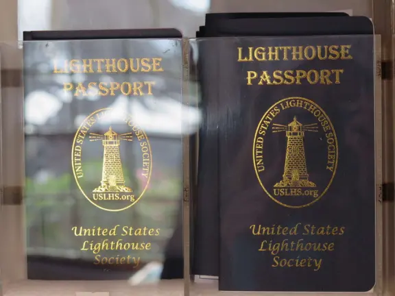 A beautiful, well-cared-for lighthouse with idyllic views of the golf course, dunes, and sea, and a garden with bright flowers.