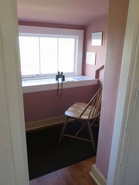 A beautiful, well-cared-for lighthouse with idyllic views of the golf course, dunes, and sea, and a garden with bright flowers.