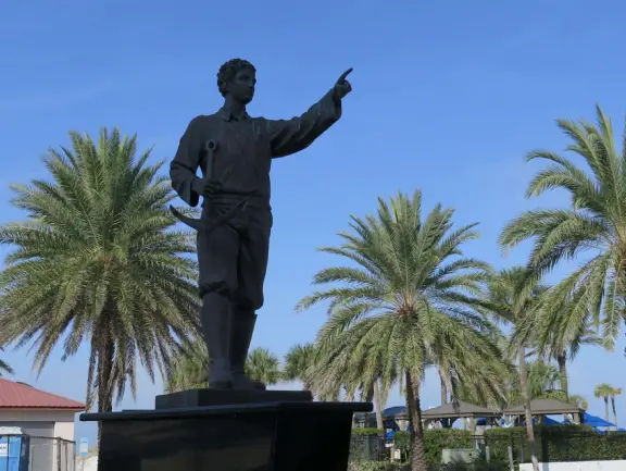 Two playgrounds (big and toddler) under huge shade canopies, on white sand, with two space nets, at the base of the gorgeous Pier 60.