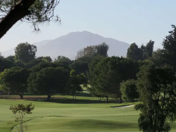 A pleasant walk past pretty houses, varied trees, and sweeping mountain views.