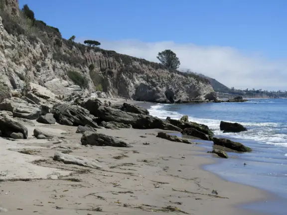 Warm, sheltered cove below Smuggler's Cave. Steep climb down.