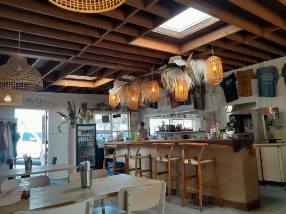 A pretty beachside town, with a wooden pier and wide windy beach with perfect views of Morro Rock, and colorful houses with gardens, backed by gently-sloping hills.